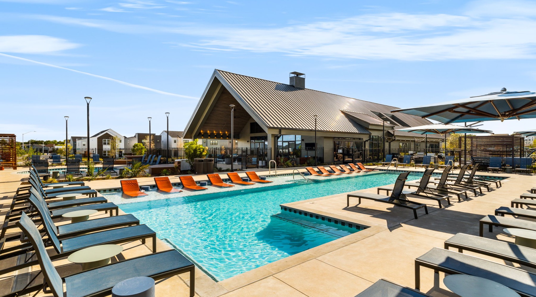 large pool and sundeck with chairs for residents of a  BTR community