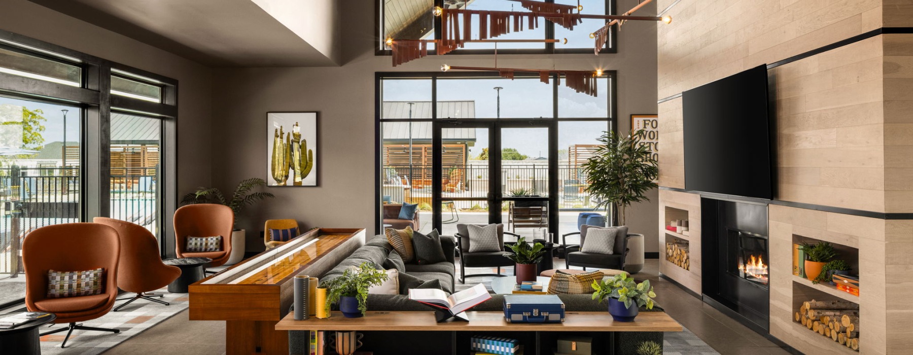 a large fireplace and seating in a clubhouse