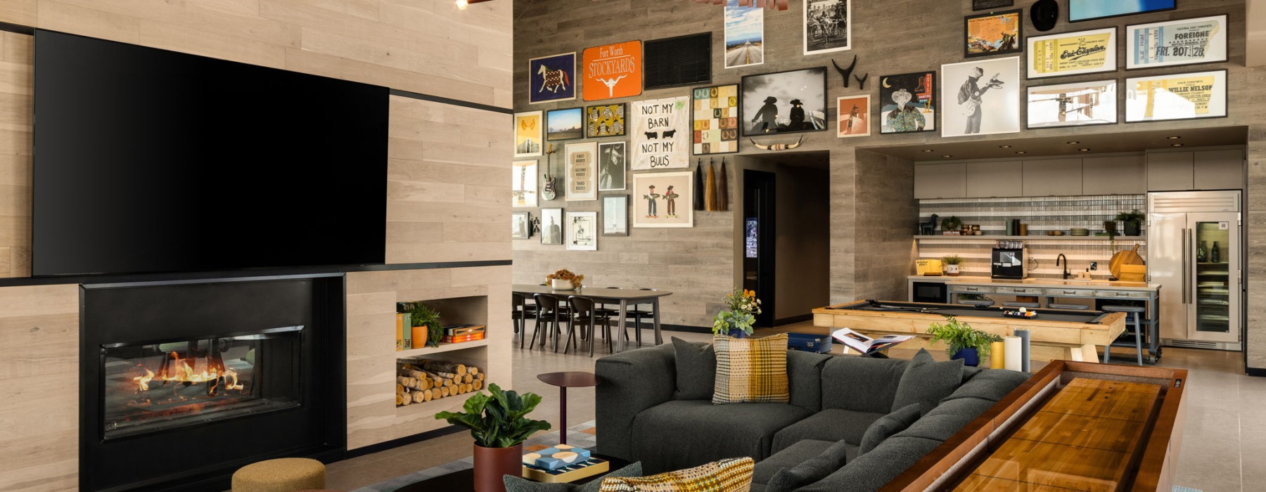 a large fireplace and seating in a clubhouse for residents