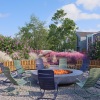 outdoor firepit area with colorful seating and landscaping