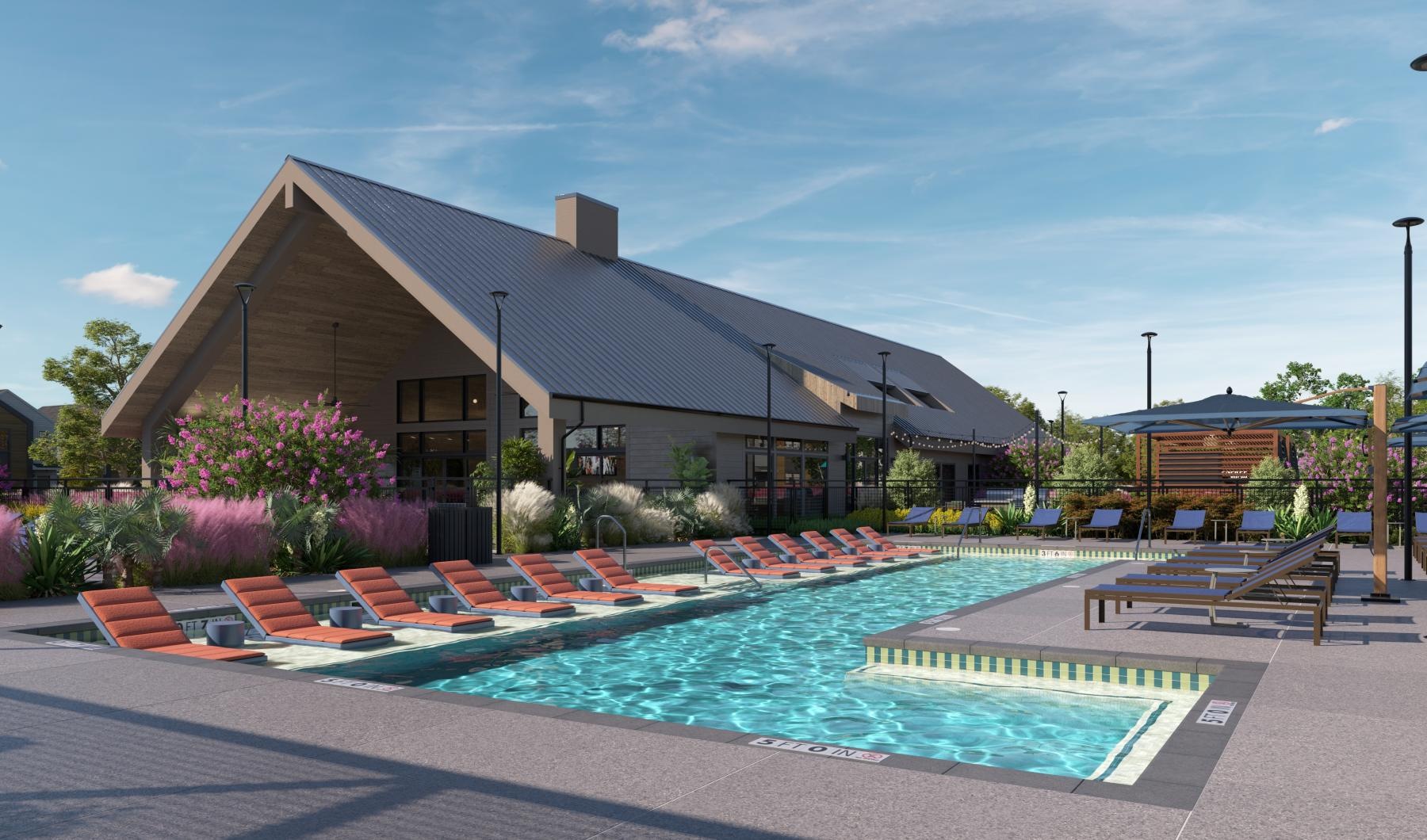 a swimming pool with chairs around it in front of a building